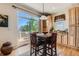 Bright dining area featuring a sliding glass door and access to the outdoor deck at 13962 Dexter Way, Thornton, CO 80602
