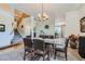 Bright dining room features stairs, chandelier and a seamless transition to the living area at 13962 Dexter Way, Thornton, CO 80602