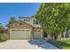 Charming two-story home featuring a stone facade, three-car garage, and mature landscaping at 13962 Dexter Way, Thornton, CO 80602