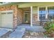 Inviting covered front porch with stone accents and vibrant flowers at 13962 Dexter Way, Thornton, CO 80602