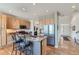 Modern kitchen featuring an island with breakfast bar and stainless-steel appliances at 13962 Dexter Way, Thornton, CO 80602