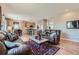 Open-concept living room that flows into the kitchen, perfect for entertaining guests at 13962 Dexter Way, Thornton, CO 80602