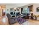 Cozy living room features a fireplace, large windows, and hardwood floors at 13962 Dexter Way, Thornton, CO 80602