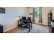 Functional home office with modern black desk, carpet, and window offering natural light at 13962 Dexter Way, Thornton, CO 80602