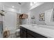 A clean bathroom with a dark vanity, tile backsplash, and a shower and bathtub at 4078 Happy Hollow Dr, Castle Rock, CO 80104