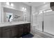 Bathroom featuring a double vanity, glass enclosed shower, and modern finishes at 4078 Happy Hollow Dr, Castle Rock, CO 80104