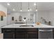 Spacious kitchen island features a sink, seating, and modern lighting fixtures above at 4078 Happy Hollow Dr, Castle Rock, CO 80104