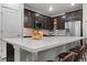 Bright kitchen island features a sink, barstool seating, and ample counter space for cooking at 4078 Happy Hollow Dr, Castle Rock, CO 80104