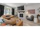 Inviting living room featuring a fireplace, flatscreen tv, and comfortable leather seating at 4078 Happy Hollow Dr, Castle Rock, CO 80104