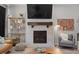 Living room showcasing a fireplace, flatscreen tv, shelving, and a cozy seating area at 4078 Happy Hollow Dr, Castle Rock, CO 80104