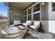 A cozy front porch with white cushions and four chairs around a table at 4078 Happy Hollow Dr, Castle Rock, CO 80104