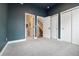 Bedroom with navy blue walls and multiple doors, including a closet and bathroom entrance at 3830 Jason St # 4, Denver, CO 80211