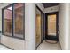 Modern townhouse entryway with glass doors, a black door and view of the interior space at 3830 Jason St # 4, Denver, CO 80211