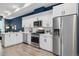 Bright kitchen featuring modern appliances, white cabinets, and stylish countertops at 3830 Jason St # 4, Denver, CO 80211