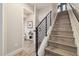 Modern staircase with sleek black railings leads to the upper levels, near half bath at 3830 Jason St # 4, Denver, CO 80211