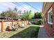 Fenced backyard with lawn and patio furniture; great outdoor space at 957 Newton St, Denver, CO 80204