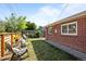 Relaxing backyard featuring a well-maintained lawn and comfortable seating area at 957 Newton St, Denver, CO 80204