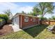 Brick home exterior with fenced backyard and ample green space at 957 Newton St, Denver, CO 80204