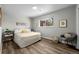 Comfortable bedroom with neutral decor, hardwood floors and a large window at 957 Newton St, Denver, CO 80204
