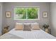 Bright bedroom featuring a large window with a view of nature at 957 Newton St, Denver, CO 80204