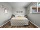 Comfortable bedroom with neutral decor, hardwood floors and a large window at 957 Newton St, Denver, CO 80204