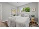 Light bedroom with hardwood floors, a large window, closet, and neutral tones at 957 Newton St, Denver, CO 80204