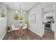 Well-lit dining area with modern light fixture and adjacent access to kitchen area. Lovely for entertaining at 957 Newton St, Denver, CO 80204