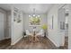 Bright dining area featuring modern light fixture and access to outdoor views through a lovely window at 957 Newton St, Denver, CO 80204