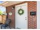 Charming front door with wreath on brick home at 957 Newton St, Denver, CO 80204