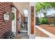 Charming brick home with a welcoming front porch, decorative wreath, and attractive landscaping at 957 Newton St, Denver, CO 80204