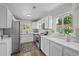 Bright kitchen with stainless steel appliances, ample counter space, and large windows bringing in natural light at 957 Newton St, Denver, CO 80204