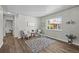 Living room with wood floors, a decorative rug, and a large window for natural light and charming décor at 957 Newton St, Denver, CO 80204