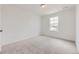 Bright bedroom with a window and plush gray carpet, perfect for relaxation and comfort at 7276 Waterleaf Trl, Littleton, CO 80125