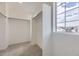 Walk-in closet with carpet, view out the window, and ample storage space at 7276 Waterleaf Trl, Littleton, CO 80125
