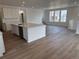 Bright, open-concept kitchen features a large center island, stainless steel appliances, and wood flooring at 7276 Waterleaf Trl, Littleton, CO 80125