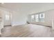 Spacious living room with hardwood floors and plenty of windows for natural light at 7276 Waterleaf Trl, Littleton, CO 80125