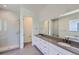 Modern bathroom with double vanity, a glass-enclosed shower, and tile floors at 20 Leafy Aster Ln, Castle Rock, CO 80104