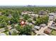 Aerial view of property showcasing a city skyline, nestled among mature trees in a quiet, residential neighborhood at 4451 Eliot St, Denver, CO 80211