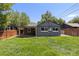 Charming backyard featuring a lush lawn and covered patio, perfect for relaxing and outdoor entertaining at 4451 Eliot St, Denver, CO 80211