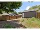 Backyard featuring a wood fence and large trees, perfect for relaxing and privacy at 4451 Eliot St, Denver, CO 80211