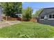 An exterior view of the backyard with green grass and a wood fence at 4451 Eliot St, Denver, CO 80211