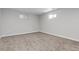 This is an unfinished basement rec room with carpet flooring and small windows at 4451 Eliot St, Denver, CO 80211