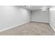 View of a carpeted basement room with painted walls and a small window at 4451 Eliot St, Denver, CO 80211