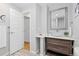 Bathroom featuring modern vanity with vessel sink and wooden cabinets at 4451 Eliot St, Denver, CO 80211