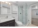 A modern bathroom with a walk-in shower and sleek fixtures at 4451 Eliot St, Denver, CO 80211