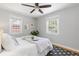 Bright bedroom with modern ceiling fan and soft, natural light from two windows at 4451 Eliot St, Denver, CO 80211