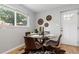 Bright dining area featuring a glass table, hardwood floors, and modern decor at 4451 Eliot St, Denver, CO 80211