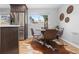 Bright dining area featuring stainless steel refrigerator, glass table, and modern decor at 4451 Eliot St, Denver, CO 80211