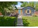 Charming home showcasing a new paint scheme, a well-maintained lawn, and a welcoming front entrance at 4451 Eliot St, Denver, CO 80211