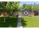 Charming home with a well-manicured front yard, steps to front door, and updated exterior finishes at 4451 Eliot St, Denver, CO 80211